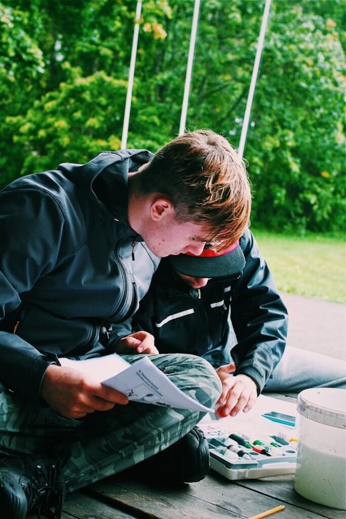 A man and child enjoy outdoor painting together during summer.